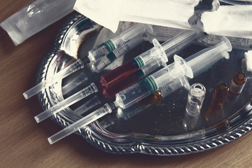 Syringes and vials on a tray. Close-up. Background.
