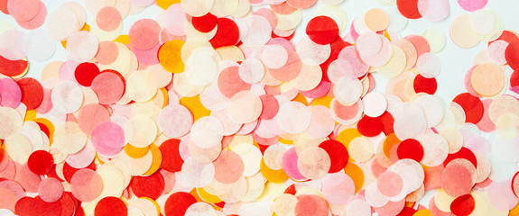 Close view of colorful bright confetti textured background.