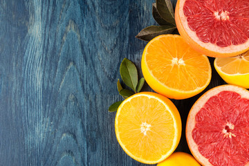 Fototapeta na wymiar Citrus fruit. Different citrus fruits with leaves of lemon, orange, grapefruit on a blue wooden table. top view
