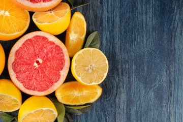 Fototapeta na wymiar Citrus fruit. Different citrus fruits with leaves of lemon, orange, grapefruit on a blue wooden table. top view