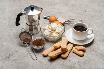 Ingredients for cooking tiramisu - Savoiardi biscuit cookies, mascarpone, cream, sugar, cocoa, coffee and egg