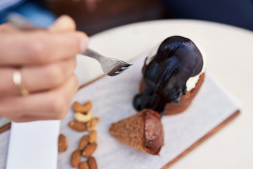 Woman eating a delicious dessert at a bistro table