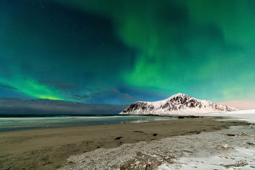 Aurora borealis over Skagsanden beach in Norway, lofotens