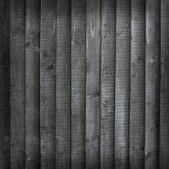 background consisting of black stained wooden planks on fencing