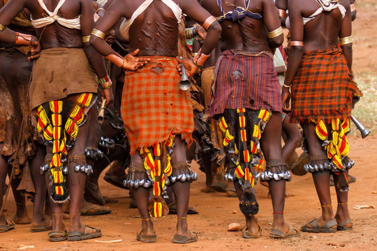 Hamar women in a village near Turmi during a bull jump ceremony.  their backs are full of scars from scourging during these ceremonies. It is a primitive tribe and the women have many decorations.
