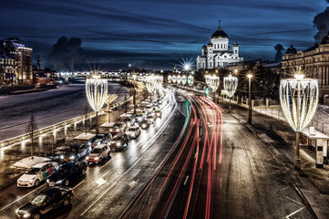 Night view of the Cathedral of Christ the Saviour, the embankment of Moscow river with it's traffic and illumination at twilight. Moscow, Russia.