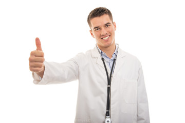 Portrait of young handsome doctor showing like gesture