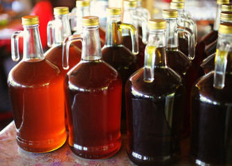 Bottles of pure organic olive oil produced in a village. Local product idea. Family business idea.  