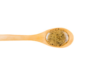 Scrubbing honey and coffee mixture on body in hot sauna helps open the pores and renew, rejuvenate the skin on body. Sauna treatment. Wooden spoon with sauna honey isolated on white background.