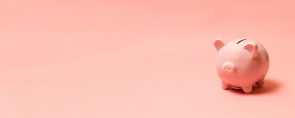 Piggy bank on living coral background. Commercial concept..Top view point, flat lay.