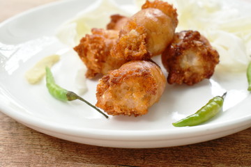 fried sour Thai sausage stuffed minced pork and glass noodles on plate