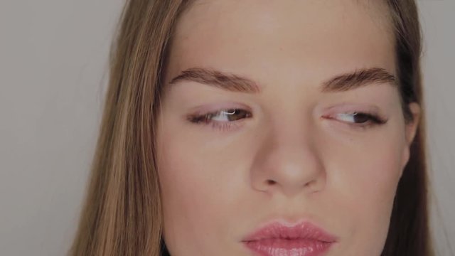 Portrait of a girl with a reflection of the annular LED light in the eyes.