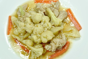 stir fried cauliflower with carrot and pork on plate