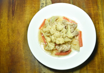 stir fried cauliflower with carrot and pork on plate