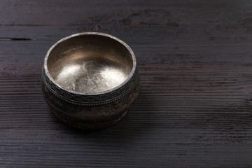 empty vintage silver salt cellar on wooden board