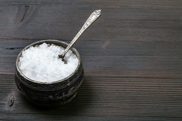 Fototapeta na wymiar silver salt cellar with coarse Sea Salt on table
