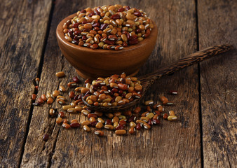  Yardlong bean seeds in a spoon and cup on old wooden floor