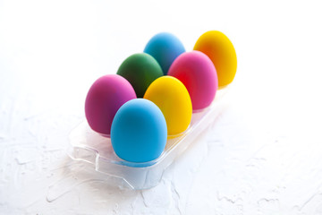 colorful Easter eggs are on a stand on a white background
