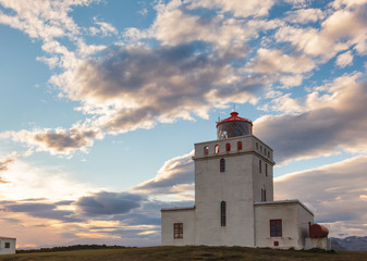 Fototapeta na wymiar Dyrholaey lighthouse at sunset Vik South coast of Iceland