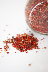 A mixture of spices. Paprika. Spices loose and in a glass jar
