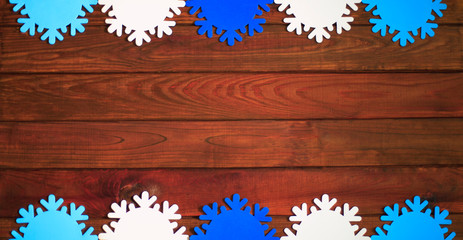 Naklejka na ściany i meble Artificial snowflakes on old wooden background Winter holidays concept