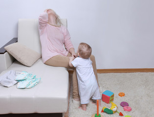 woman sits with her child, postpartum depression