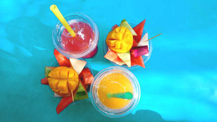 Close up desert with fresh fruit and juicy. Mixed Fruit on blue background - Summer concept