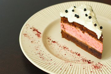 cake mousse berry, chocolate biscuit - dessert is sweet and tasty. piece of cake. food background. top