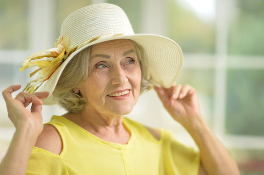 Portrait of beautiful senior woman in yellow dress