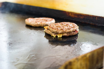 Cooking and Fraying Burgers and Hamburgers on Barbecue