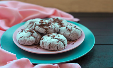 Chocolate cookies on plate on dark wooden background, top view. Food, junk-food, culinary, eating concept.