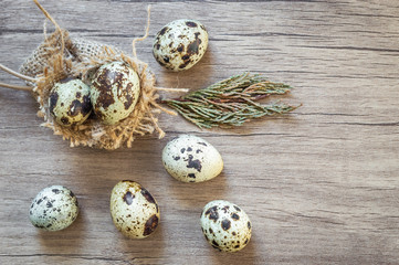 Quail eggs on brown wooden background. Flat lay, top view. Easter concept.