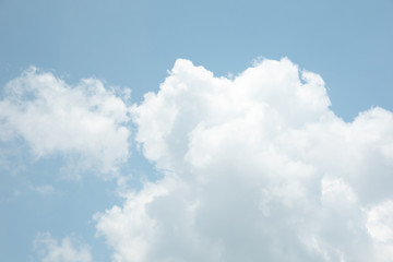 The sky is bright blue. There are clouds floating through. Feel relax when looking. See the sun on the sun.