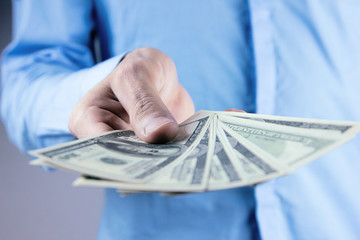  man displaying a spread of cash