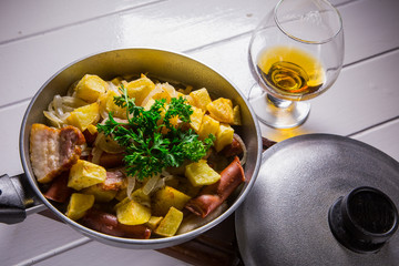 fried egg with sausage and potato in a frying pan