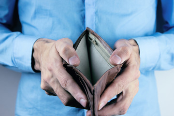 young man holding empty wallet