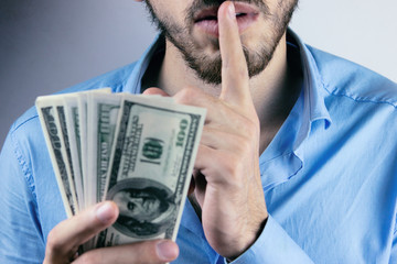 Bribery people with dollar bills in hand and quiet gesture