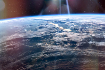 High altitude view of the Earth from space, blue planet with white clouds and deep black space. Elements of this image furnished by NASA.