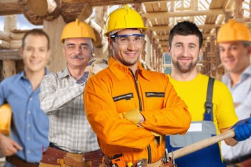 Building, construction, development, teamwork and people concept -  Group of builders in hardhats