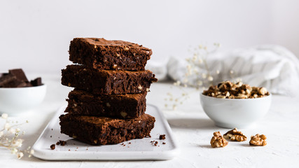 A stack of chocolate brownies on white background, homemade bakery and dessert. Bakery,...