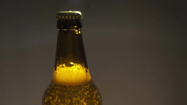 beer bootle sparkling bubbles close up slowmotion