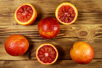 Red blood oranges on wooden table. Top view