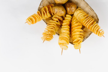  Potato chips on a stick in a basket of potatoes