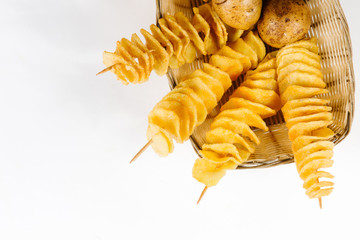  Potato chips on a stick in a basket of potatoes