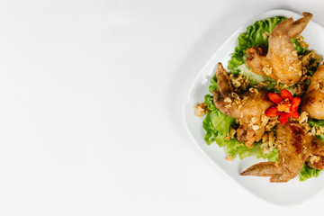 Traditional oriental cuisine of  Vietnam. Breaded Chicken Wings with green salad  with copy space