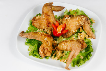 Traditional oriental cuisine of  Vietnam. Breaded Chicken Wings with green salad 