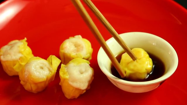 Man keeping dim sum  to dip in sauce , in studio Chiangmai  Thailand