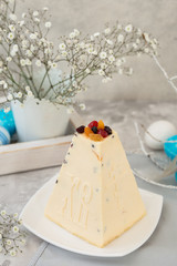 Caramel cottage cheese dessert (Paskha), Easter cakes with icing sugar and colorful painted eggs on table. Traditional Easter treats of Russia and Ukraine for Orthodox Easter. Easter symbols