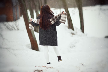 Young girl walking in a snowy park