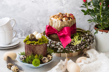 Caramel cottage cheese dessert (Paskha), Easter cakes with icing sugar and colorful painted eggs on table. Traditional Easter treats of Russia and Ukraine for Orthodox Easter. Easter symbols